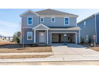 Charming two-story home features a welcoming front porch and an attached two-car garage at 2102 Cherry Creek Rd, Haw River, NC 27258