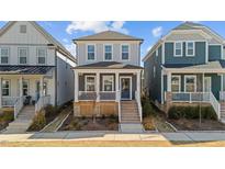 Charming two-story home features a welcoming front porch and neat landscaping in a friendly neighborhood setting at 283 Dry Canyon Dr, Wendell, NC 27591