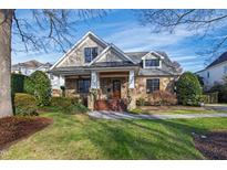Charming stone and siding two-story home with a well-manicured front lawn and inviting curb appeal at 2920 Claremont Rd, Raleigh, NC 27608