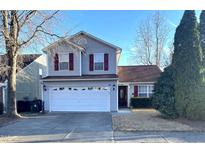 Charming two-story home featuring red shutters and a two-car garage at 4002 Rothfield Ln, Raleigh, NC 27616