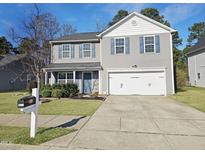 Charming two-story home with a well-maintained lawn and a two car attached garage at 5321 Carnelian Dr, Raleigh, NC 27610