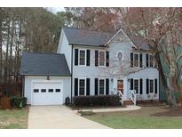 Charming two-story home with a two car garage, landscaped yard, and welcoming front entrance at 5924 Eaglesfield Dr, Raleigh, NC 27613