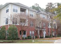 Attractive condominium complex with brick facade, neutral siding and well-maintained landscaping at 622 Ives Ct # 622, Chapel Hill, NC 27514