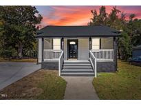 Charming one-story home with a welcoming front porch and newly renovated stairs at 703 Vance St, Henderson, NC 27536