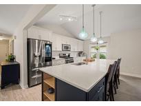 Bright kitchen with a large center island, stainless steel appliances, and stylish pendant lighting at 104 Chris Ct, Cary, NC 27511