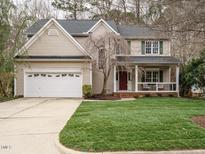 Charming two-story home with a well-manicured lawn and a welcoming front porch at 110 Forest Run Pl, Cary, NC 27518
