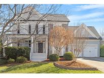 Charming gray two-story home featuring a landscaped front yard and two-car garage at 11342 Oakcroft Dr, Raleigh, NC 27614