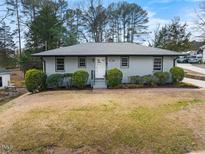 Charming single story home with fresh gray paint, manicured bushes, and a well-kept lawn at 1917 Bivins St, Durham, NC 27707