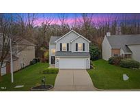 Charming two-story home features a well-maintained lawn and attached two car garage at 315 Inkster Cv, Raleigh, NC 27603