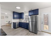 Beautiful kitchen featuring stylish blue cabinets, stainless steel appliances, and modern countertops at 315 Inkster Cv, Raleigh, NC 27603