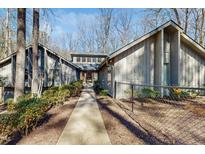 Charming home with mature landscaping and walkway leading to the front door at 3306 Whitfield Rd, Chapel Hill, NC 27514