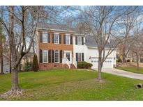 Charming two-story brick and siding home with a well-maintained lawn and two-car garage at 3401 Tunas St, Raleigh, NC 27616