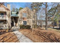 Attractive townhouse with mulched lawn, walkway, steps, and an outdoor porch at 3803 Chimney Ridge Pl # 102, Durham, NC 27713