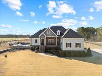 Beautiful home with a manicured lawn, mature trees, and an in-ground pool at 3805 Barberry Lake Ct, Fuquay Varina, NC 27526