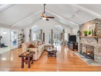 Spacious living room boasts a vaulted ceiling, hardwood floors, and a cozy fireplace at 520 Log Barn Rd, Pittsboro, NC 27312