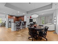 Open-concept living room with a modern kitchen, dining area, and comfortable seating at 618 N Boylan Ave # 518, Raleigh, NC 27603