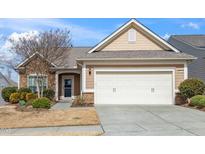 Charming single Gathering home with a two car garage and manicured front yard at 711 Gaston Manor Dr, Durham, NC 27703