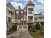 Charming townhome with brick accents, a welcoming porch, and beautifully landscaped grounds at 9211 Calabria Dr # 117, Raleigh, NC 27617