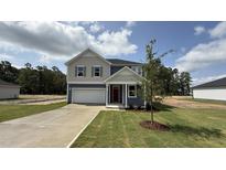 Charming two-story home with a well-manicured lawn and a red front door at 140 Gobbler Dr, Smithfield, NC 27577