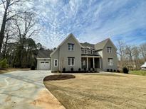Stunning two-story home with a manicured lawn and an attached garage with a long driveway at 1405 Song Bird Crest Way, Raleigh, NC 27613