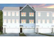 Three-story townhome showcasing charming architectural details and a two-car garage at 1410 Chrysalis Pl, Apex, NC 27502
