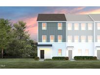 Inviting gray two-story townhouse with green lawn and tree at dusk at 1481 Hasse Ave, Apex, NC 27502