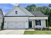 Charming single-Gathering home featuring a two-car garage, dark shutters and door, and a well-manicured lawn at 201 W Saltgrass Ln, Smithfield, NC 27577