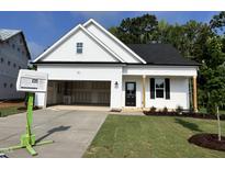 Charming, newly constructed one-story home with an attached garage and a manicured lawn at 201 W Saltgrass Ln, Smithfield, NC 27577