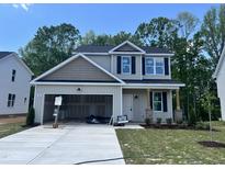 Charming two-story home with an attached two-car garage and front yard at 211 W Saltgrass Ln, Smithfield, NC 27577