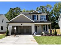 Charming two-story home with a spacious garage and well-manicured lawn, perfect for families at 211 W Saltgrass Ln, Smithfield, NC 27577