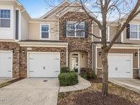 Charming townhome with stone accents, neutral siding, attached garages, and an inviting front entrance at 2459 Memory Ridge Dr, Raleigh, NC 27606