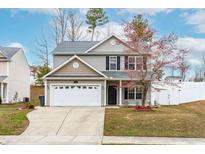 Charming two-story home featuring a gray exterior, two-car garage, and well-manicured lawn at 314 Star Ruby Dr, Knightdale, NC 27545