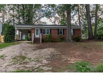 Charming brick ranch with covered parking and front yard at 3429 Dogwood Dr, Raleigh, NC 27604