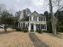 Charming two-story home featuring black shutters, a chimney, and a walkway leading to the front door at 3624 Singleleaf Ln, Raleigh, NC 27616