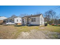 Modest single-story home with a small porch and a yard with a mix of grass and dirt at 415 Cherry St, Oxford, NC 27565