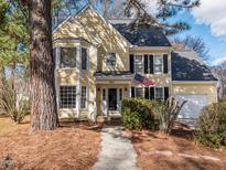 Charming two-story home with a well-manicured lawn, beautiful yellow siding, and an American flag at 4617 Atterbury Ct, Raleigh, NC 27604