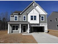Two-story home with gray siding, white trim, and a spacious driveway leading to a two-car garage at 548 Jocund St # 15, Rolesville, NC 27571