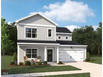 Charming two-story home features a welcoming front porch and a two-car garage with lush green lawn at 564 Jocund St # 11, Rolesville, NC 27571
