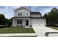 Charming two-story home with a gray exterior, a well-manicured lawn and a two car garage at 564 Jocund St # 11, Rolesville, NC 27571