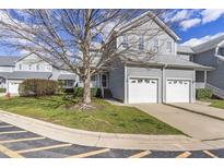Charming townhouse featuring a two-car garage and beautifully landscaped front yard at 8310 Hempshire Pl # 106, Raleigh, NC 27613