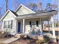 Charming covered front porch with rocking chairs and a welcoming entrance to the home at 10 Elaine Cir, Durham, NC 27703