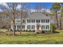 Charming two-story home with a manicured lawn, black shutters, and a welcoming front porch at 106 Legault Dr, Cary, NC 27513