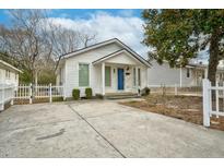 Charming single-story home with a blue door, white picket fence, and concrete driveway at 1132 Gay St, Rocky Mount, NC 27804