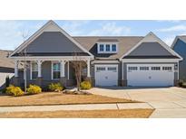 Charming home with a two-car garage, manicured lawn, and inviting front porch at 1605 Orange Tip St, Fuquay Varina, NC 27526