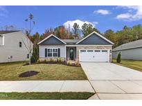 Charming single-Gathering home with a two-car garage and well-manicured lawn and Autumn foliage at 203 Jetson Creek Way, Youngsville, NC 27596