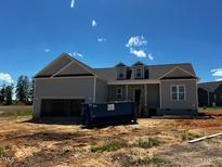 Charming single-story home featuring gray siding, a dark shingled roof, and a spacious garage at 28 Golden View Pl, Zebulon, NC 27597