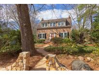 Charming two-story home with a brick path, beautiful landscaping, and multiple windows at 300 Mccauley St, Chapel Hill, NC 27516