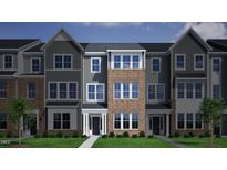 Charming three-story townhome with brick and siding, and well-manicured landscaping, inviting curb appeal at 307 Chesapeake Commons St # 100, Garner, NC 27529