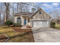 Charming single Gathering home with a two car garage, blue front door and inviting curb appeal at 308 N English Hill Ln, Hillsborough, NC 27278
