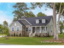 Charming one-story home featuring stone accents, gray siding, dormer windows and a welcoming front porch at 31 Priming Way, Angier, NC 27501